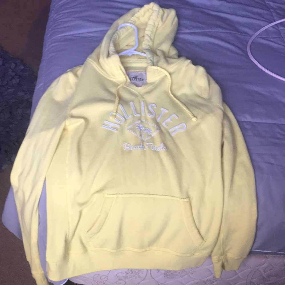A yellow L hoodie from hollister still new
